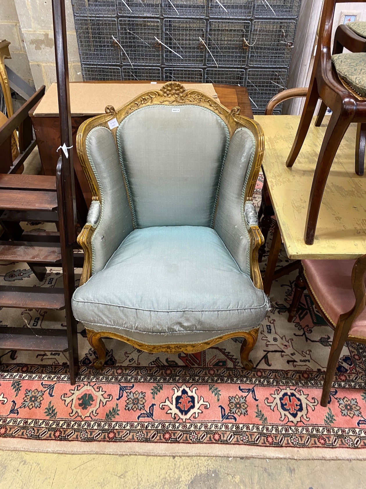 A Louis XV style carved giltwood fauteuil, width 70cm, depth 70cm, height 102cm